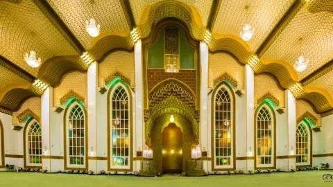 interior of Al Salam Mosque in Dubai, displaying Islamic architectural elements with golden geometric patterns